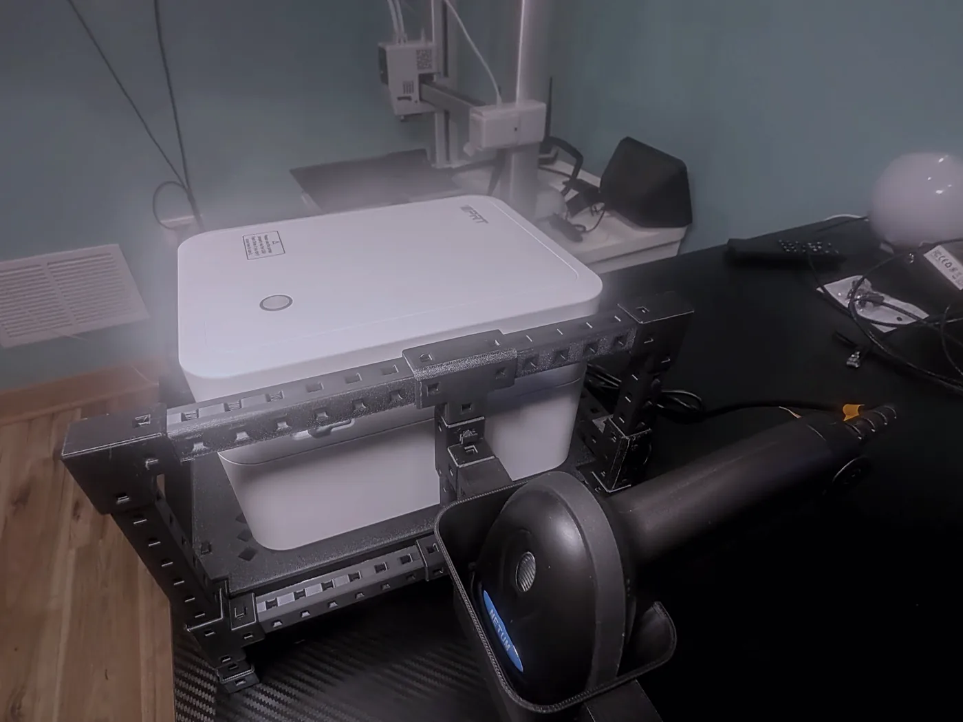 The TabStamp rack on a bar counter: label printer on top, hands-free scanner in its cup at the front, scanner mast rising behind.